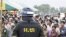 A Cambodian military policeman stands watch during the ground breaking ceremony of a Chinese funded road at Koun Damrey village, Banteay Meanchey province, about 15 kilometers (9 miles) east of Cambodia's border with Thailand, February 15, 2011.
