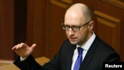 Ukrainian Prime Minister Arseny Yatseniuk, shown addressing legislators in Kyiv in December, says IMF officials are pressing hard for implementation of promised reforms by the government, including overhauling the state gas company.