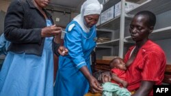 A health worker prepares to vaccinate a child against malaria, at Mitundu Community Hospital, in Malawi's capital of Lilongwe, April 23, 2019.