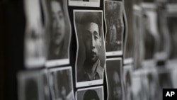FILE - Portraits of victims of the June 4, 1989 bloodshed are displayed at the June 4 Memorial Museum run by pro-democracy activists in Hong Kong.