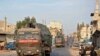 FILE - A Turkish military convoy drives through a town in Syria's northwestern Idlib province, Oct. 20, 2020. An little known Islamist group said it was behind an attack Saturday that targeted a Turkish military outpost in the province.