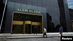FILE - People walk outside the building where the offices of Brazilian construction firm Odebrecht are in Buenos Aires, Argentina, May 24, 2017. 