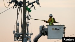 Crews work on power lines damaged by Hurricane Michael in Panama City Beach, Florida, Oct. 11, 2018. 