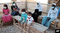 FILE - Rohingya refugees sit as they wait for medical checkup in Samaritan's Purse diphtheria clinic in Cox's Bazar, Bangladesh, Jan. 21, 2018. 