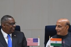 Visiting U.S. Defense Secretary Lloyd Austin (L) interacts with Indian Defense Minister Rajnath Singh during a joint media briefing in New Delhi, March 20, 2021.