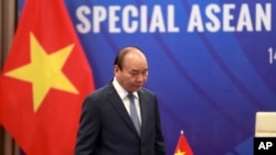 FILE - Vietnamese Prime Minister Nguyen Xuan Phuc walks to his desk ahead of the Special ASEAN summit on COVID-19 in Hanoi, Vietnam, April 14, 2020. 