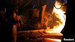 FILE - A steelworker is seen in a mill in Chau Khe village outside Hanoi, Vietnam, March 30, 2018.