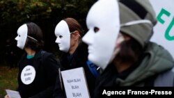 Climate activists hold placards reading "Blah Blah Blah" to mock statements by world leaders during a protest at Festival Park in Glasgow on the sidelines of the COP26 UN Climate Summit on Nov. 1, 2021.