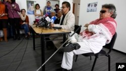 Ivan Marquez, chief negotiator of the Revolutionary Armed Forces of Colombia, second from right, talks to reporters as Jesus Santrich, right, Victoria Sandino, left, and Joaquin Gomez, second left, listen in Bogota, Colombia, Dec. 6, 2016. Marquez had said Colombia looked "ridiculous" because of delays in the implementation of peace agreements.