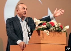 Turkish Foreign Minister Mevlut Cavusoglu, gestures as he speaks during a campaign gathering in Metz, eastern France, March 12, 2017.
