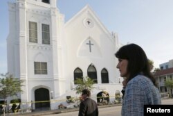 FILE - South Carolina Governor Nikki Haley walks between television interviews outside the Emanuel African Methodist Episcopal Church in Charleston, South Carolina, June 19, 2015.