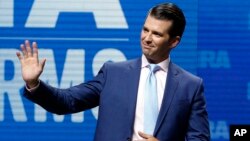 FILE - Donald Trump Jr. waves from the stage at the National Rifle Association in Dallas, May 4, 2018.