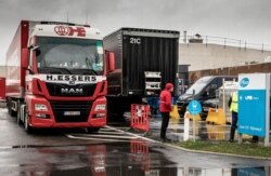 Trucks wait outside of loading bays at Pfizer Manufacturing in Puurs, Belgium, Dec. 21, 2020.