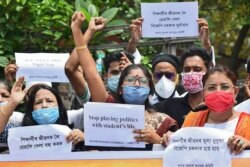 Activists of Assam Pradesh Congress Committee (APCC) take part in a protest demanding the government postpone college entrance exams, in Guwahati, India, Aug. 28, 2020.