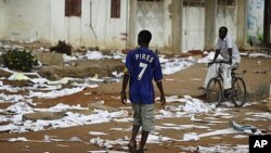 A Senegalese youth walks past the ransacked office of state electrical company Senelec in the capital Dakar, June 28, 2011