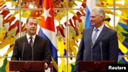 Cuba's President Miguel Diaz-Canel watches Russia's Prime Minister Dmitry Medvedev as he speaks at the Revolution Palace in Havana, Cuba, Oct. 3, 2019. 