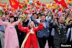 FILE - People react as they see North Korean leader Kim Jong Un during a mass rally and parade in the capital's main ceremonial square, May 10, 2016.