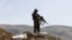FILE - An Afghan National Army (ANA) soldier keeps watch during a patrol in Dand Ghori district of Baghlan province, Afghanistan. March 15, 2016. 