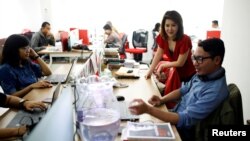 The leader of the Indonesian Solidarity Party, Grace Natalie, second from right, chats with staff at the party's headquarters in Jakarta, Indonesia, March 19, 2018.