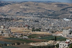 FILE - A general view shows the Al-Baqaa Palestinian refugee camp, near Amman, Jordan, June 16, 2020.