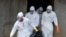 Medical workers of the Liberian Red Cross, wearing a protective suit, carry the body of a victim of the Ebola virus in a bag on Sept. 4, 2014 in the small city of Banjol, 30 kilometers from Monrovia. 