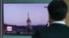 A man watches a TV report about North Korea's missile firing with file footage, at Seoul Train Station in Seoul, South Korea, April 6, 2017. The letters read "U.S., North, Scud missile-ER." 