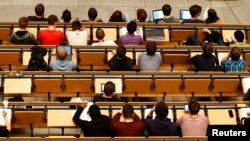 FILE PHOTO: Students attend a lecture in the auditorium of a university in Munich, Germany, May 25, 2016. 