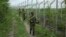 India’s Border Security Force soldiers patrol near the India-Pakistan international border fencing at Garkhal in Akhnoor, west of Jammu, India, Aug. 13, 2019. 