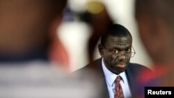 FILE - Kizza Besigye, leader of opposition party Forum for Democratic Change (FDC), speaks to the media announcing his candidature for the 2016 presidential election in the capital Kampala.