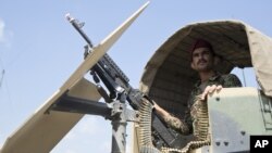 Afghanistan's National Army soldier stands guard in his vehicle in Camp Khogyani in Nangarhar province, east of Kabul, Afghanistan. 