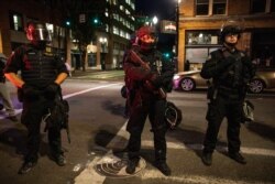 Portland police stand guard, Aug. 29, 2020, in Portland, Ore.