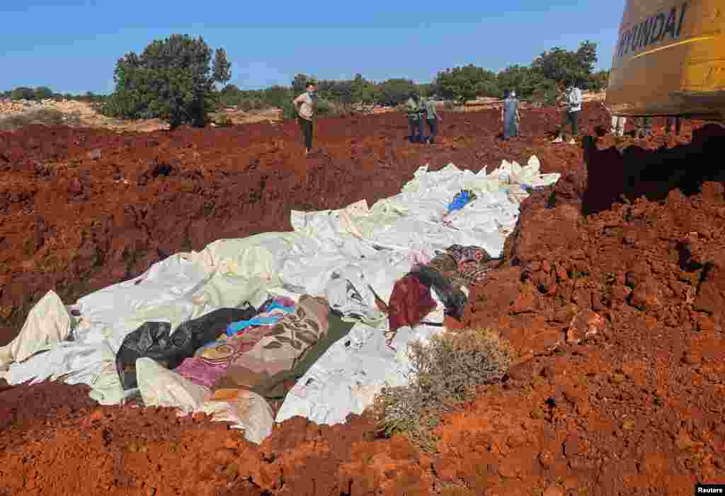 Bodies of victims are placed at a mass grave in Derna after a powerful storm and heavy rainfall hit Libya, Sept. 12, 2023.