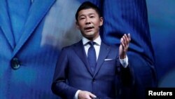 FILE - Yusaku Maezawa, the chief executive of Zozo, which operates Japan's popular fashion shopping site Zozotown and is officially called Start Today Co, speaks at an event launching the debut of its formal apparel items, in Tokyo, Japan, July 3, 2018.