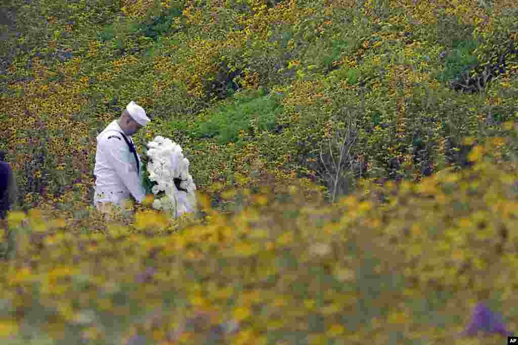 Navy Quartermaster Matthew Konchan of Johnstown, Pa., stands in a field of black-eyed susans as he waits to participate in a wreath laying ceremony with Secretary of the Interior Sally Jewell during a memorial service at the Flight 93 National Memorial, Sept. 11, 2013.