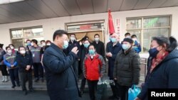 Chinese President Xi Jinping inspects the novel coronavirus prevention and control work at Anhuali Community in Beijing, Feb. 10, 2020.
