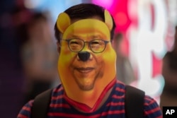 A protester wears a mask during a demonstration in Hong Kong, Friday, Oct. 18, 2019. Hong Kong protesters masqueraded as Winnie the Pooh and other characters in defiance of a government ban on face coverings at public gatherings.