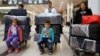 FILE - The al-Qassab family, Iraqi Christian refugees from Mosul, at Beirut international airport ahead of their travel to the United States, Lebanon, Feb. 8, 2017.