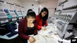 Women work on ruanas, which are traditional, pancho-style Colombian garments, in Nobsa, Colombia, Aug., 25, 2017. A ruana will be given to Pope Francis on his upcoming visit to Colombia.