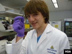 Jack Andraka, 16, with his pancreatic cancer sensor strip at the Johns Hopkins lab in Baltimore. (Courtesy Jane Andraka)