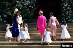 Britain's Catherine, Duchess of Cambridge and Meghan Markle's friend, Canadian fashion stylist Jessica Mulroney holds bridesmaids hands as they arrive for the wedding ceremony of Britain's Prince Harry, Duke of Sussex and U.S. actress Meghan Markle.