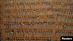 FILE - An aerial view of crosses casting shadows at the Parque Taruma cemetery is seen amid the coronavirus pandemic, in Manaus, Brazil, June 15, 2020.