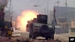 This image made from Associated Press video shows a tank during clashes in Fallujah, June 26, 2016.