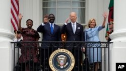 First lady Jill Biden and President Joe Biden, along with Kenya's President William Ruto and his wife Rachel Ruto, wave from the Blue Room Balcony during a State Arrival Ceremony on the South Lawn of the White House, May 23, 2024, in Washington.