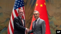 Wang Yi, right, the director of the Communist Party's Central Foreign Affairs Commission Office shakes hands with White House national security adviser Jake Sullivan, left, at Yanqi lake in Beijing, Aug. 27, 2024.