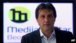 Serbian Defense Minister Bratislav Gasic leaves after a press conference in Belgrade, Serbia, Tuesday, Dec. 8, 2015.