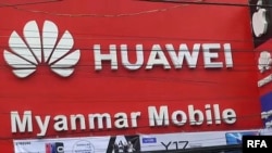 A Huawei sign is seen above a storefront along a busy street in central Myanmar's Mandalay region, May 2019. (RFA video screenshot)