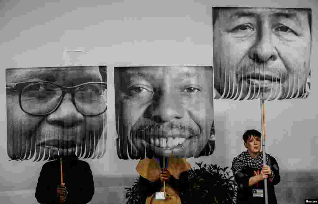 Activists hold placards during a protest in support of political prisoners at the COP29 United Nations climate change conference, in Baku, Azerbaijan.