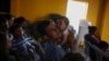Jose, 31, from Guatemala, holds his infant daughter during a church service at the Agape World Mission shelter, where many Central American and Mexican migrants stay while trying to reach the U.S. or request asylum, in Tijuana, Mexico, Sept. 12, 2019. 