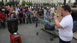 In this Dec. 13, 2019 photo, congressional candidate Bryan Russell campaigns at San Martin Plaza in Lima, Peru. (AP Photo/Martin Mejia)