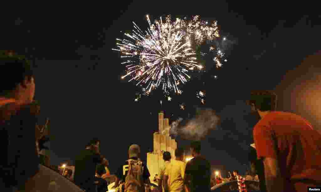 Fireworks explode in the sky in Benghazi as people celebrate after polling stations closed during Libya's national election, July 7, 2012. 